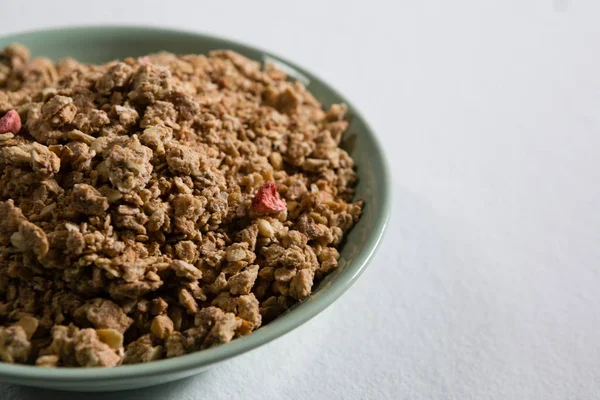 Bowl of granola on white — Stock Photo, Image