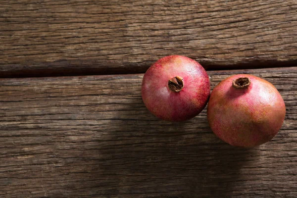Pomegranates on a wooden table — Stock Photo, Image