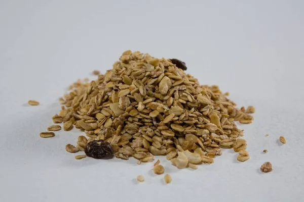 Crunchy granola scattered on white background — Stock Photo, Image