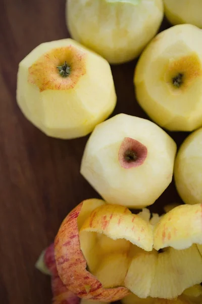 Fresh apples by peels on table — Stock Photo, Image