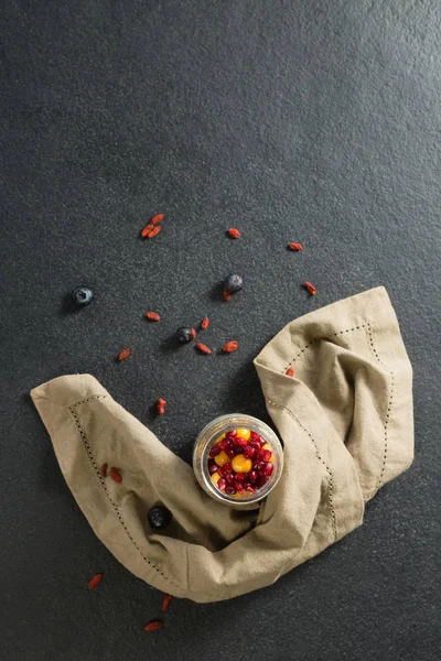 Yogurt with pomegranates and golden berries — Stock Photo, Image