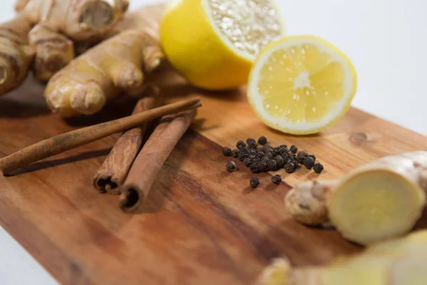 Lemon and various spices on board — Stock Photo, Image