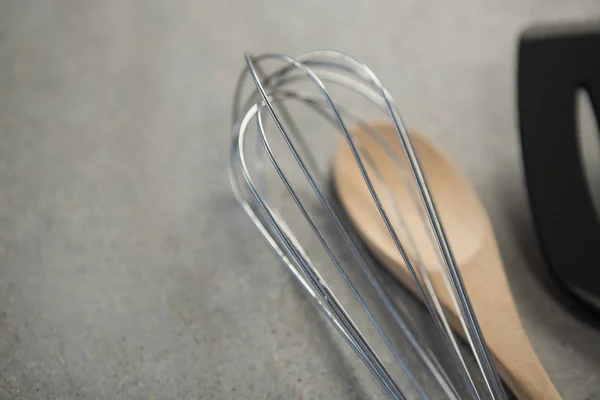 Wire whisk and wooden spoon — Stock Photo, Image