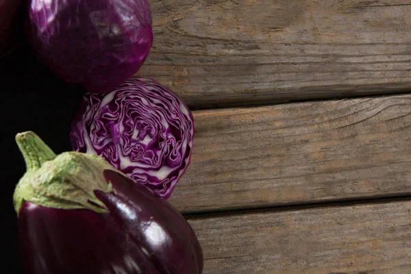 Red cabbage and eggplant on wooden table — Stock Photo, Image