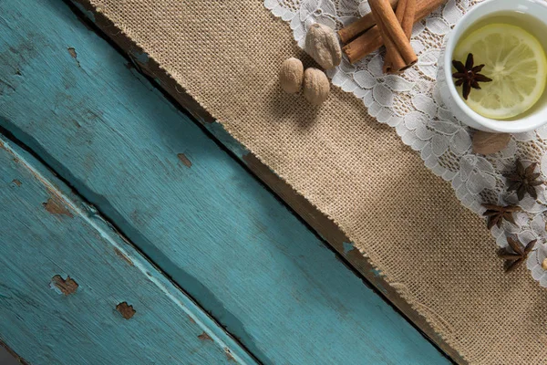 Ginger tea with cinnamon on burlap — Stock Photo, Image