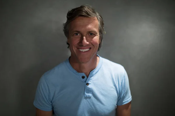 Hombre sonriendo sobre fondo gris — Foto de Stock