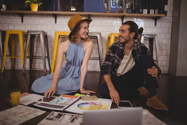 Designers sitting with sheets on floor — Stock Photo, Image