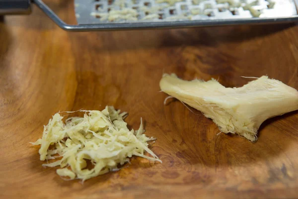 Ginger and grater in plate — Stock Photo, Image