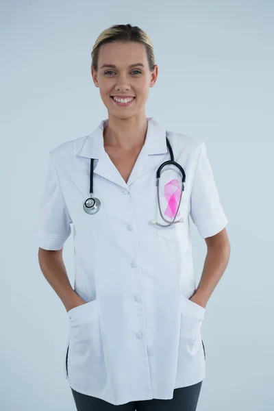 Female doctor with Breast Cancer Awareness ribbon — Stock Photo, Image