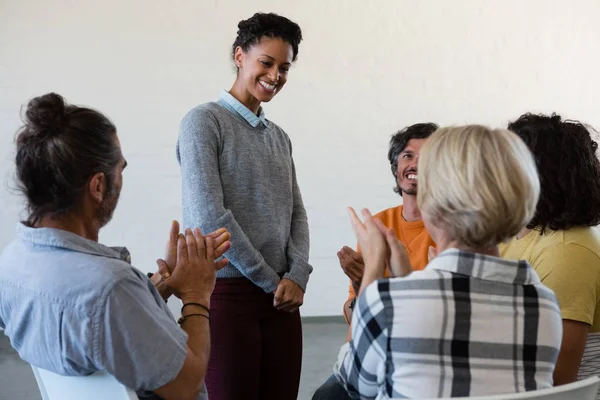 Smiling friends looking at woman — Stock Photo, Image