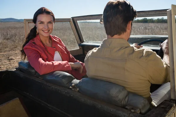Woman sitting by man in off road vehicle — Stock Photo, Image
