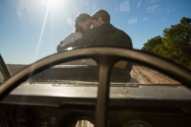 couple seen through off road vehicle windshield clipart