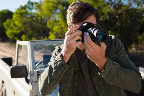 Hombre fotografiando desde cámara por vehículo —  Fotos de Stock