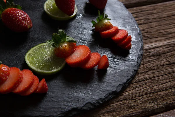 Sliced strawberries and lemon — Stock Photo, Image