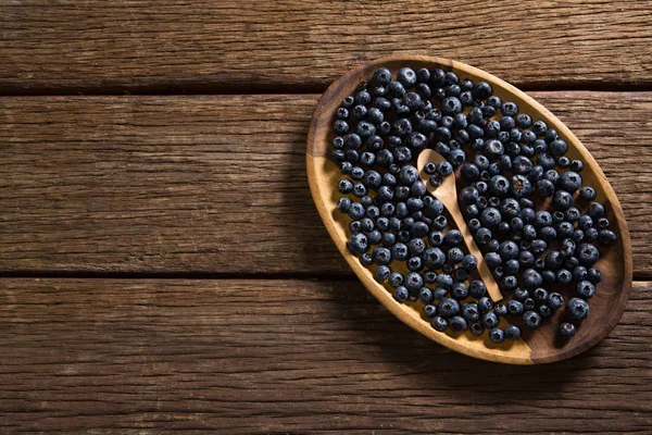 Arándanos en plato de madera — Foto de Stock