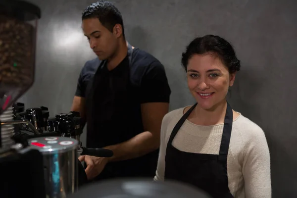 Waitress standing at counter with colleague — Stock Photo, Image