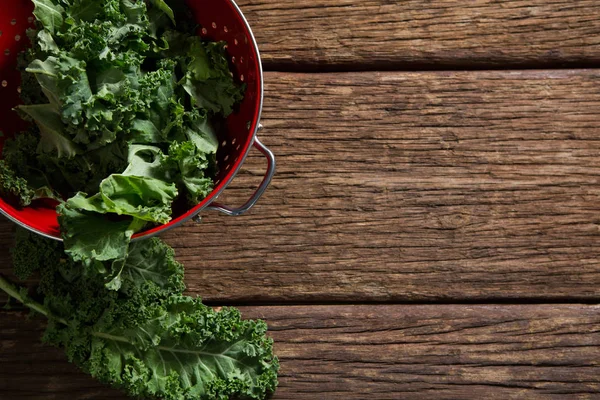 Mustard greens on wooden table — Stock Photo, Image