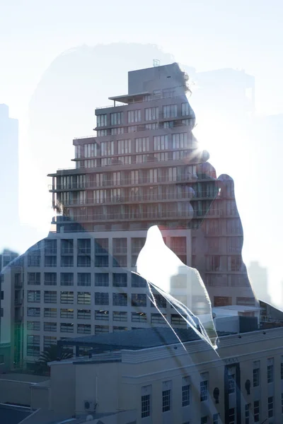 Businessman talking on phone reflecting on window — Stock Photo, Image