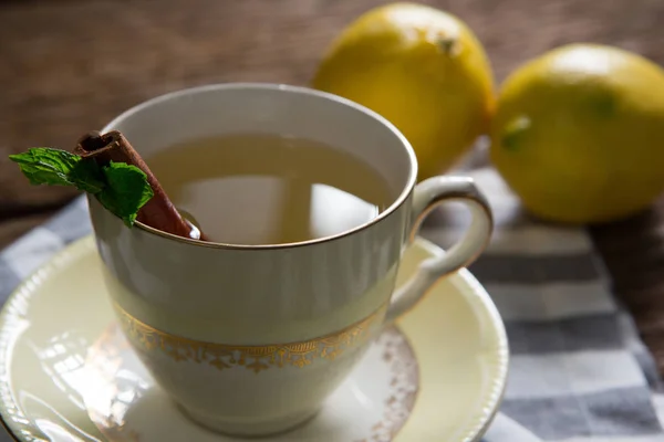 Cup of tea with lemon and cinnamon stick — Stock Photo, Image