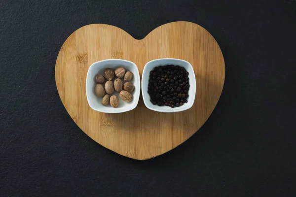 Muskaatnoten en zwarte peper zaden — Stockfoto