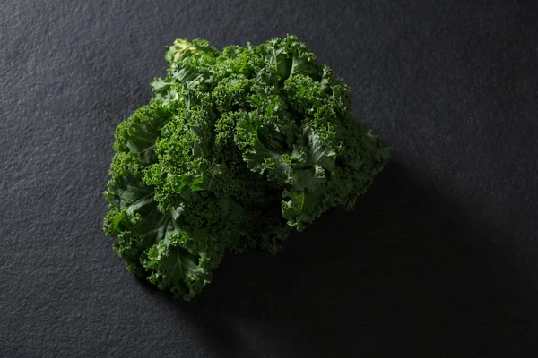 Mustard greens on black background — Stock Photo, Image