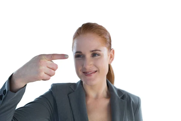 Businesswoman looking at index finger — Stock Photo, Image