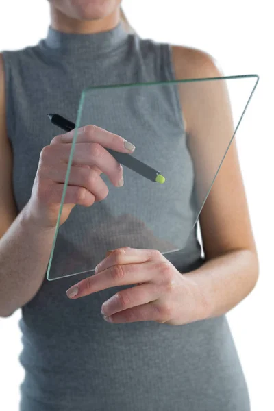 Businesswoman writing on glass interface — Stock Photo, Image