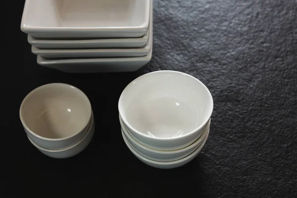 Clay bowls on black background — Stock Photo, Image