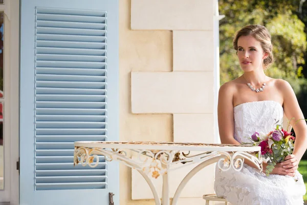 Mariée réfléchie avec bouquet — Photo