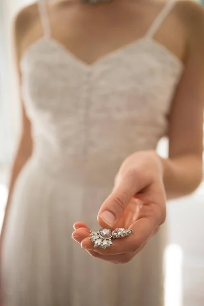 Bride holding necklace at home — Stock Photo, Image