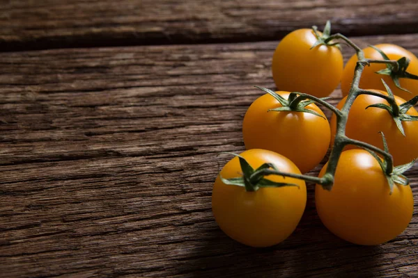 Gelbe Tomaten auf Holztisch — Stockfoto