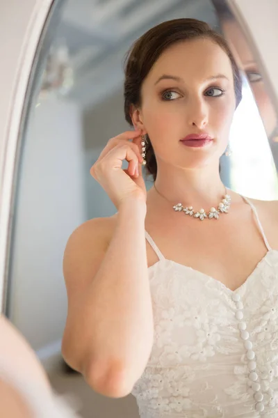 Beautiful bride wearing earring — Stock Photo, Image