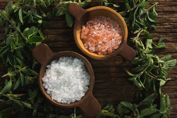 Salts in a bowl with herbs — Stock Photo, Image