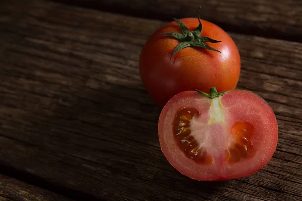 Tomato on wooden table — Stock Photo, Image