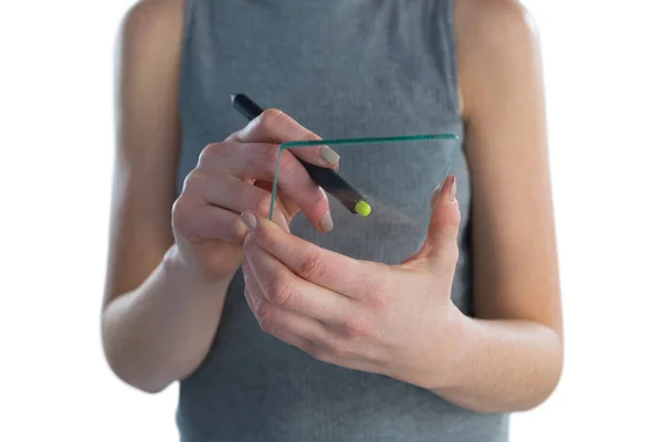 Businesswoman writing on transparent glass interface — Stock Photo, Image