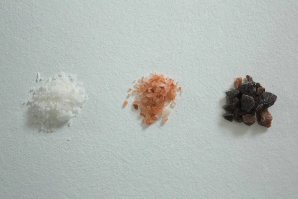 Various salts on white background — Stock Photo, Image