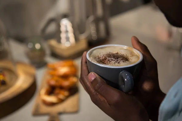 Mid section of man holding espresso — Stock Photo, Image