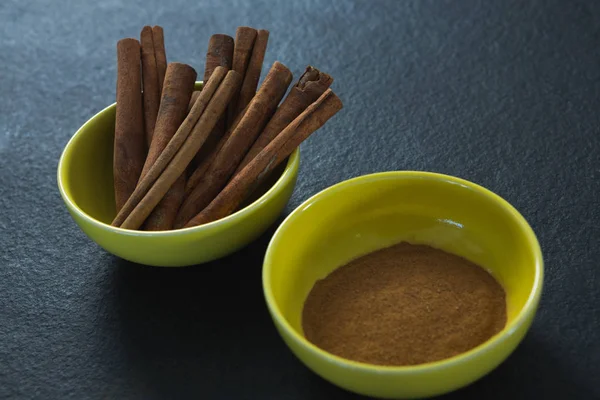 Cinnamon sticks and powder in a bowl — Stock Photo, Image