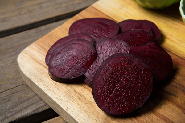 Slice of beetroots on chopping board — Stock Photo, Image