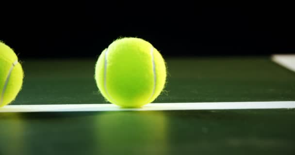 Tennis balls arranged on white line — Stock Video