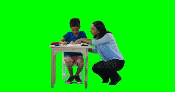 Mother helping her son while doing homework — Stock Video