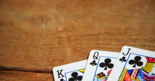 Playing cards on wooden table — Stock Video