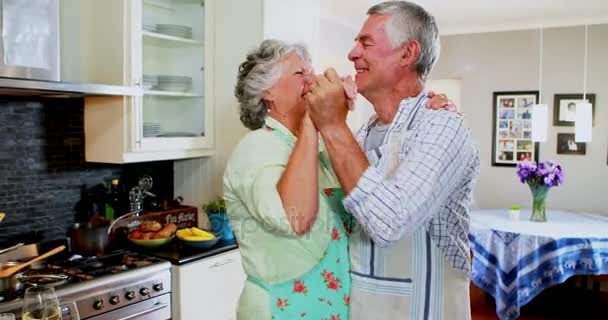 Romantic senior couple dancing in kitchen — Stock Video