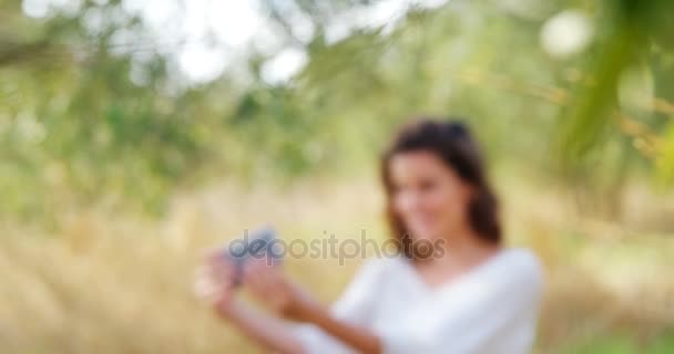 Woman taking selfie from mobile phone in olive farm — Stock Video