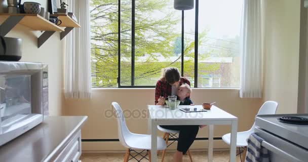 Mother feeding breakfast to her baby — Stock Video