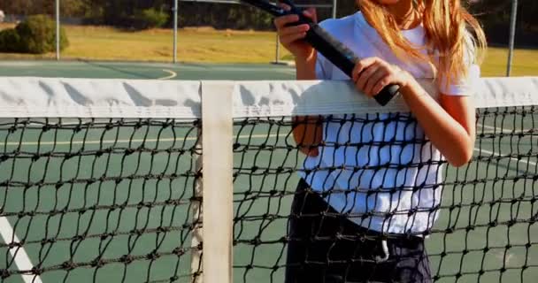 Schoolgirl standing with racket — Stock Video