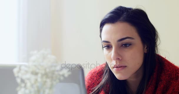 Woman eating popcorn while using laptop — Stock Video