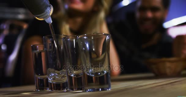 Camarero tequila en vasos de chupito en bar — Vídeo de stock