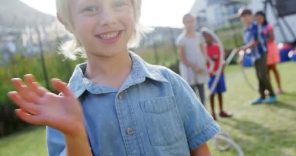 Портрет щасливого хлопчика, що жестикулює на задньому дворі — стокове відео