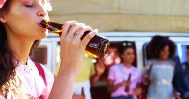 Frau trinkt mit Freunden Flasche Bier im Park — Stockvideo